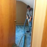 Tech cleaning carpet in attic